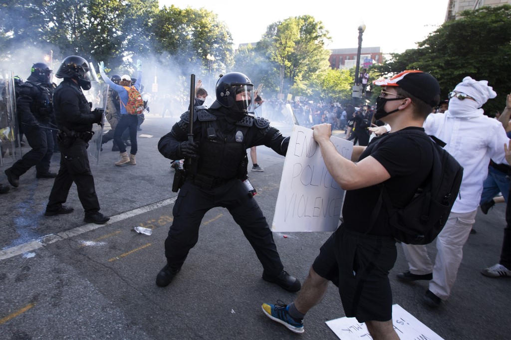 US police officers clash with protesters near the White House on 1 June (AFP)