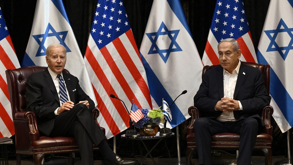 US President Joe Biden listens to Israeli Prime Minister Benjamin Netanyahu in Tel Aviv on 18 October 2023 (Brendan Smialowski/AFP)
