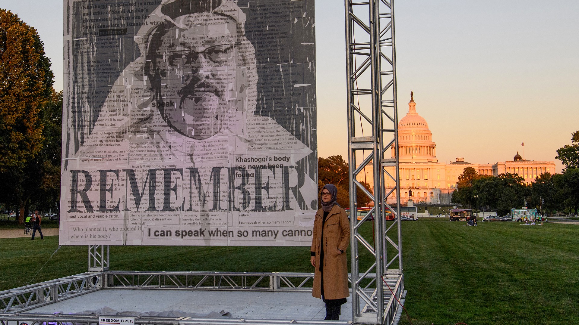 Turkish writer Hatice Cengiz (R), fiancée of Saudi journalist and dissident Jamal Khashoggi, poses next to a portrait of Khashoggi after unveiling it on the National Mall in Washington, DC., on October 1, 2021