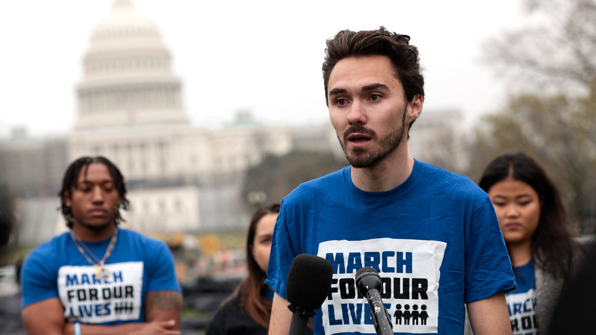 arjory Stoneman Douglas High School shooting survivor David Hogg speaks in front of reporters at an installation of body bags assembled on the National Mall by Gun Control activist group March For Our Lives on March 24, 2022 in Washington, DC.