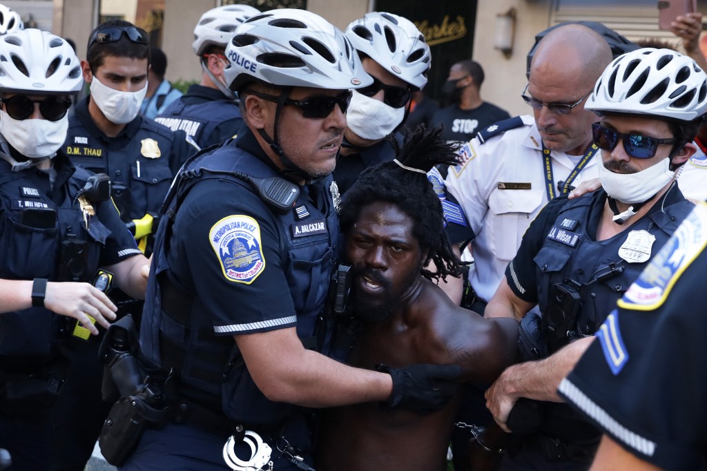 Police arrest a man at Black Lives Matter Plaza in Washington on 4 July (AFP)