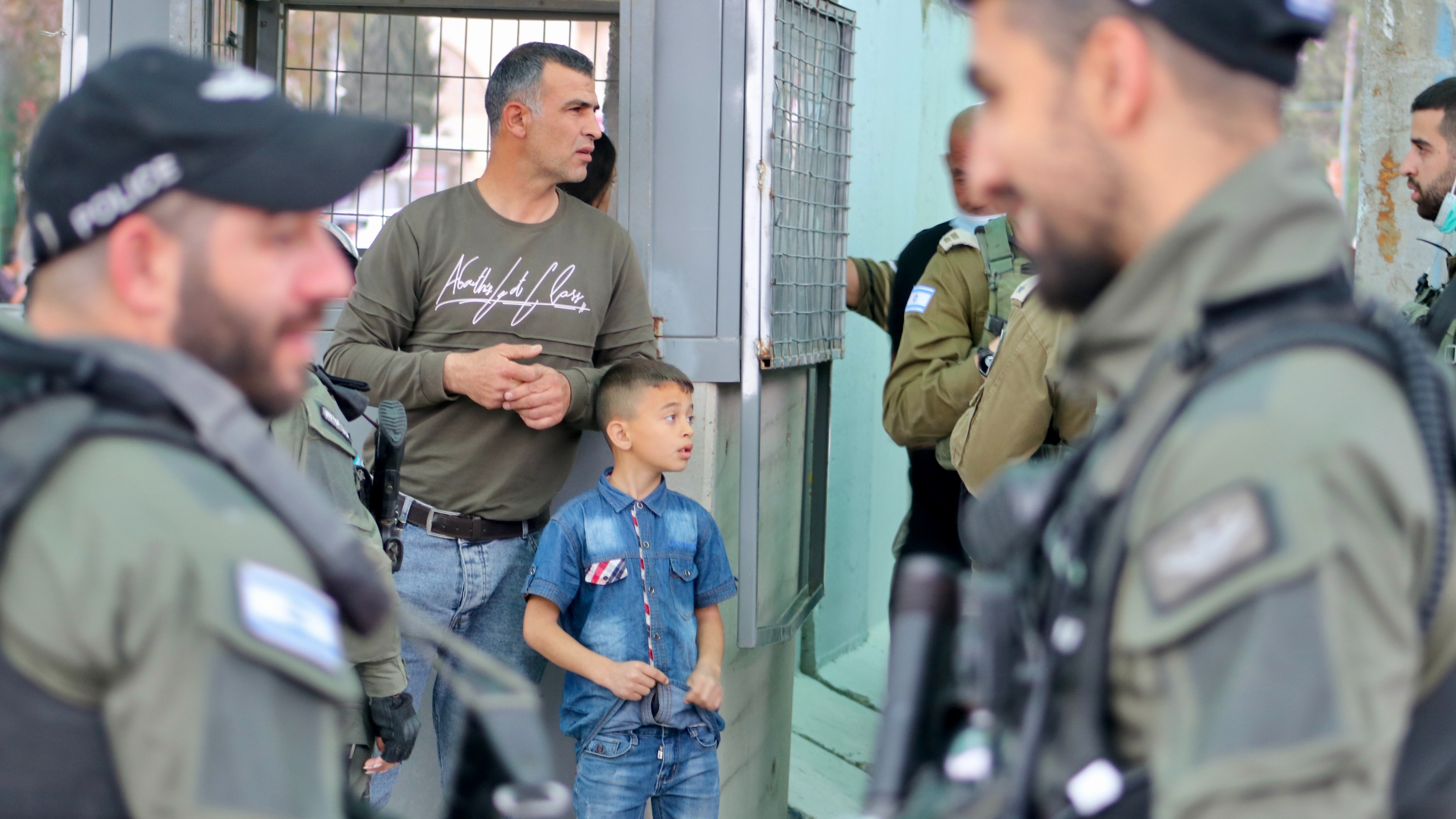 Israeli soldiers check IDs of Palestinians crossing from Bethlehem into Jerusalem on 8 April 2022. (MEE/Mosab Shawer)