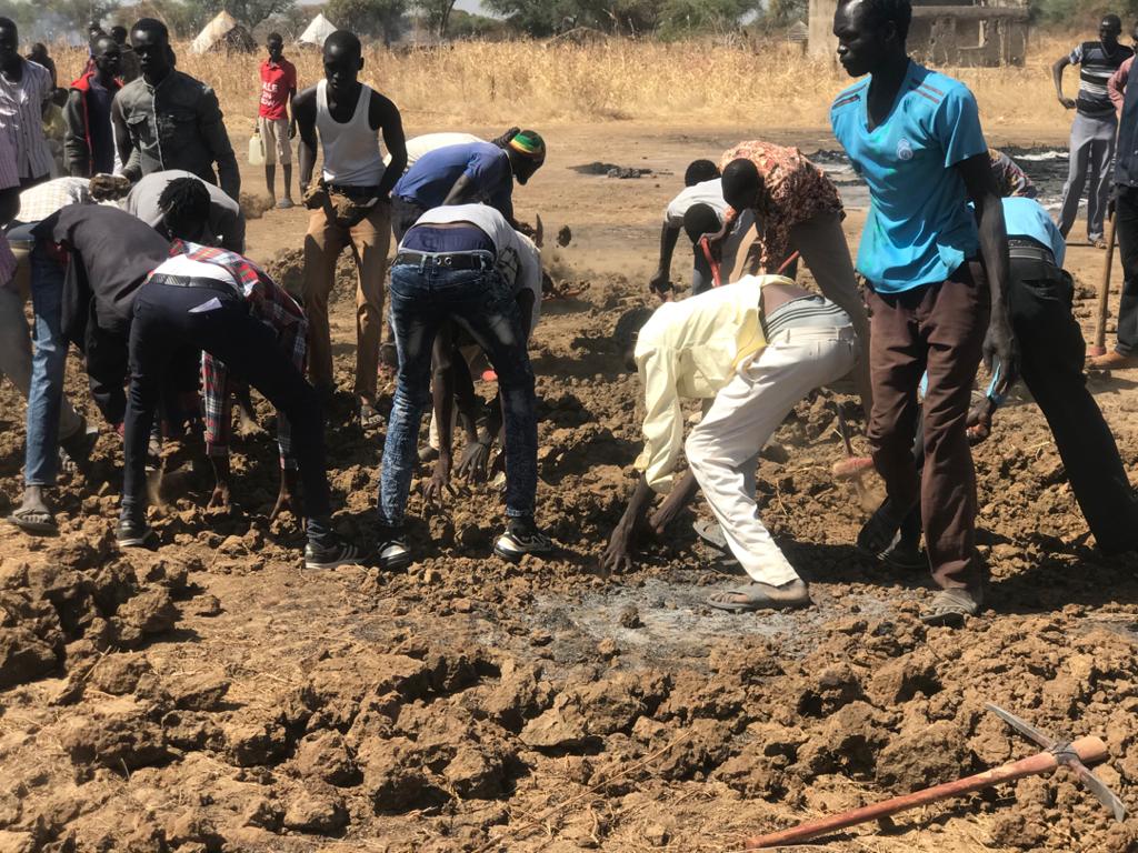 Villagers dig a mass grave to bury the dead who were killed by Arab tribesman targeting the Dinka tribe (MEE/Peter Oborne)
