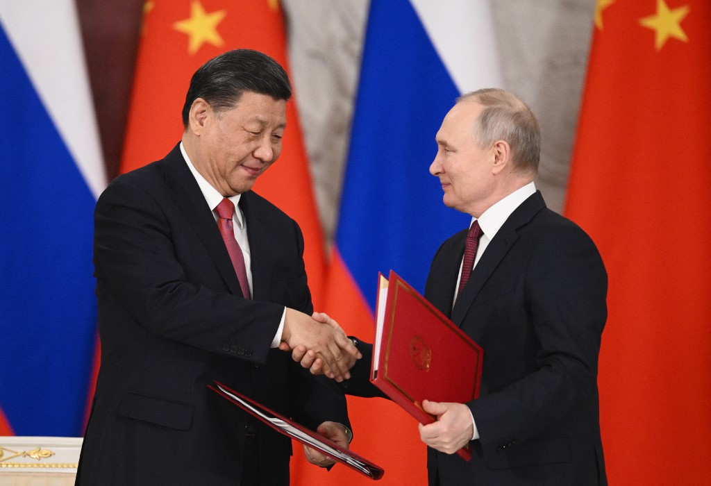 Russian President Vladimir Putin and China's President Xi Jinping shake hands during a signing ceremony following their talks at the Kremlin in Moscow on March 21, 2023.