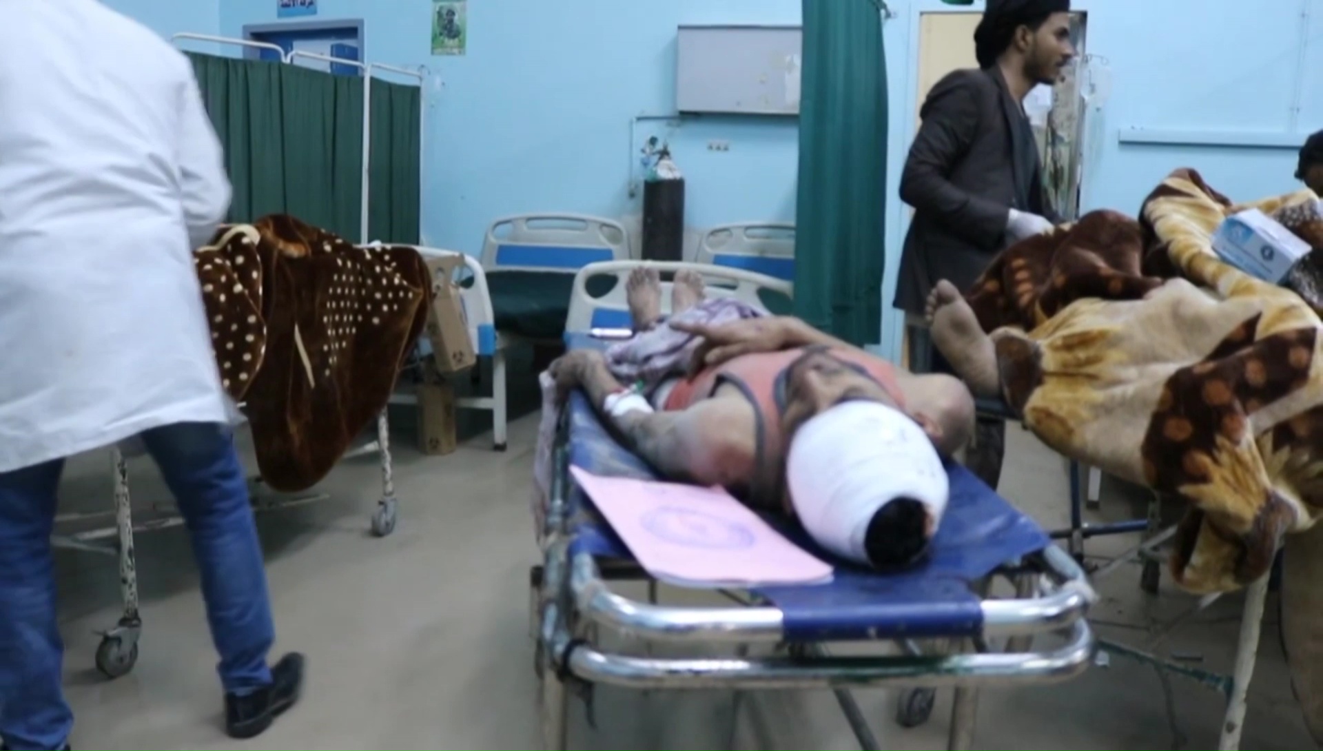 Men wounded by a Saudi-led military coalition air strike lying on beds at a hospital in Dhamar (AFP)