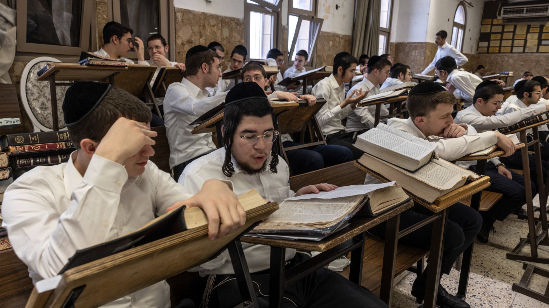 Ultra-Orthodox Jewish students study the Torah at the Ponevezh Yeshiva in the central Israeli city of Bnei Brak on 27 February (AFP/Menahem Kahana)